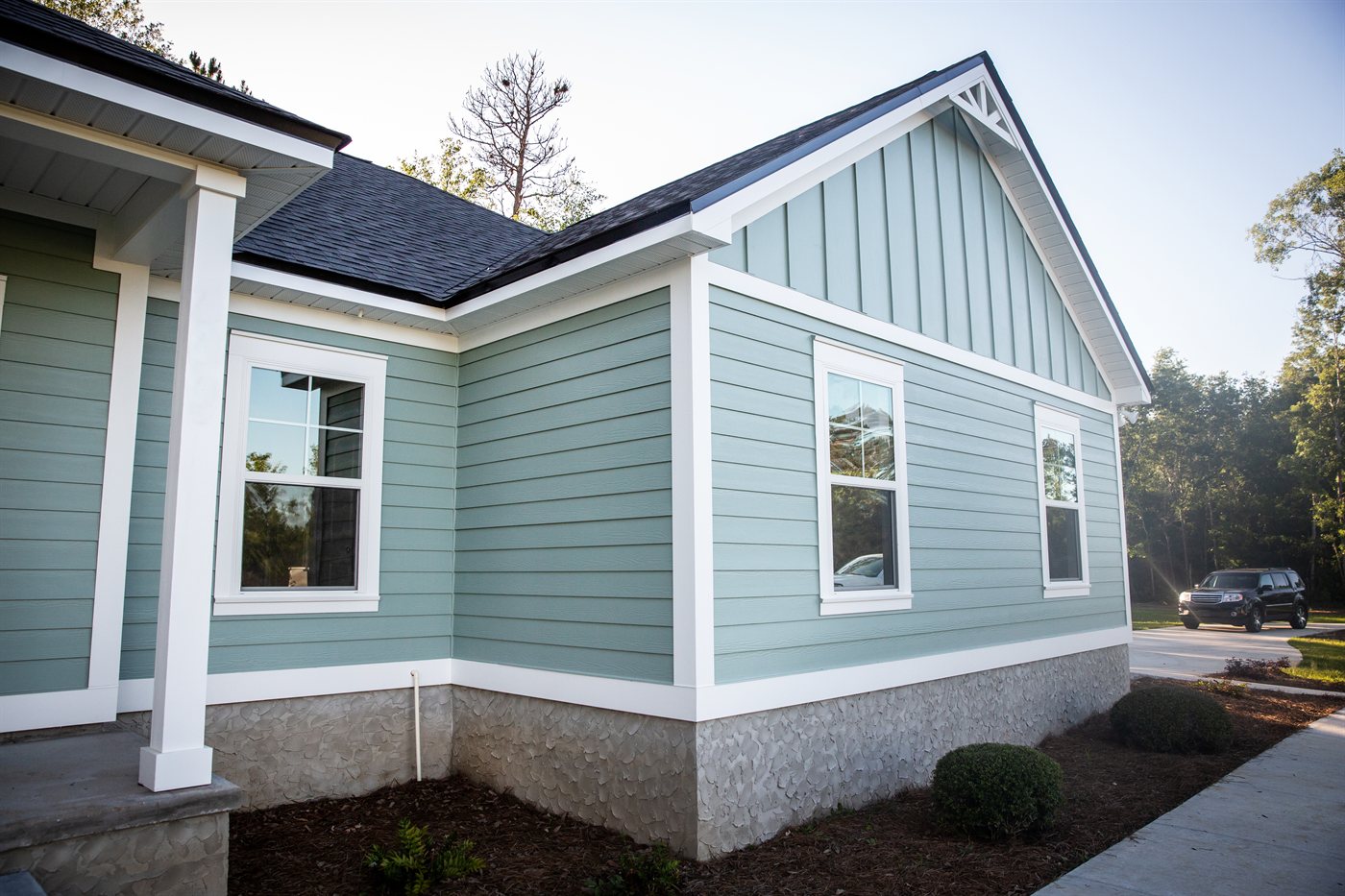 Classic white lap siding farmhouse with wraparound porch