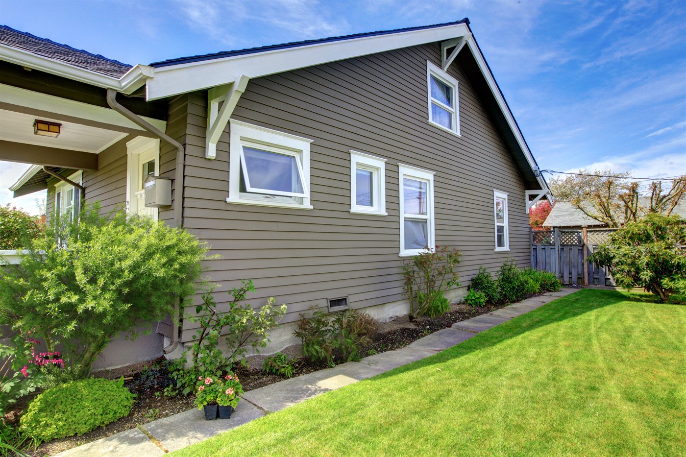 Dark gray Hardie lap siding with board-and-batten accent and dormers