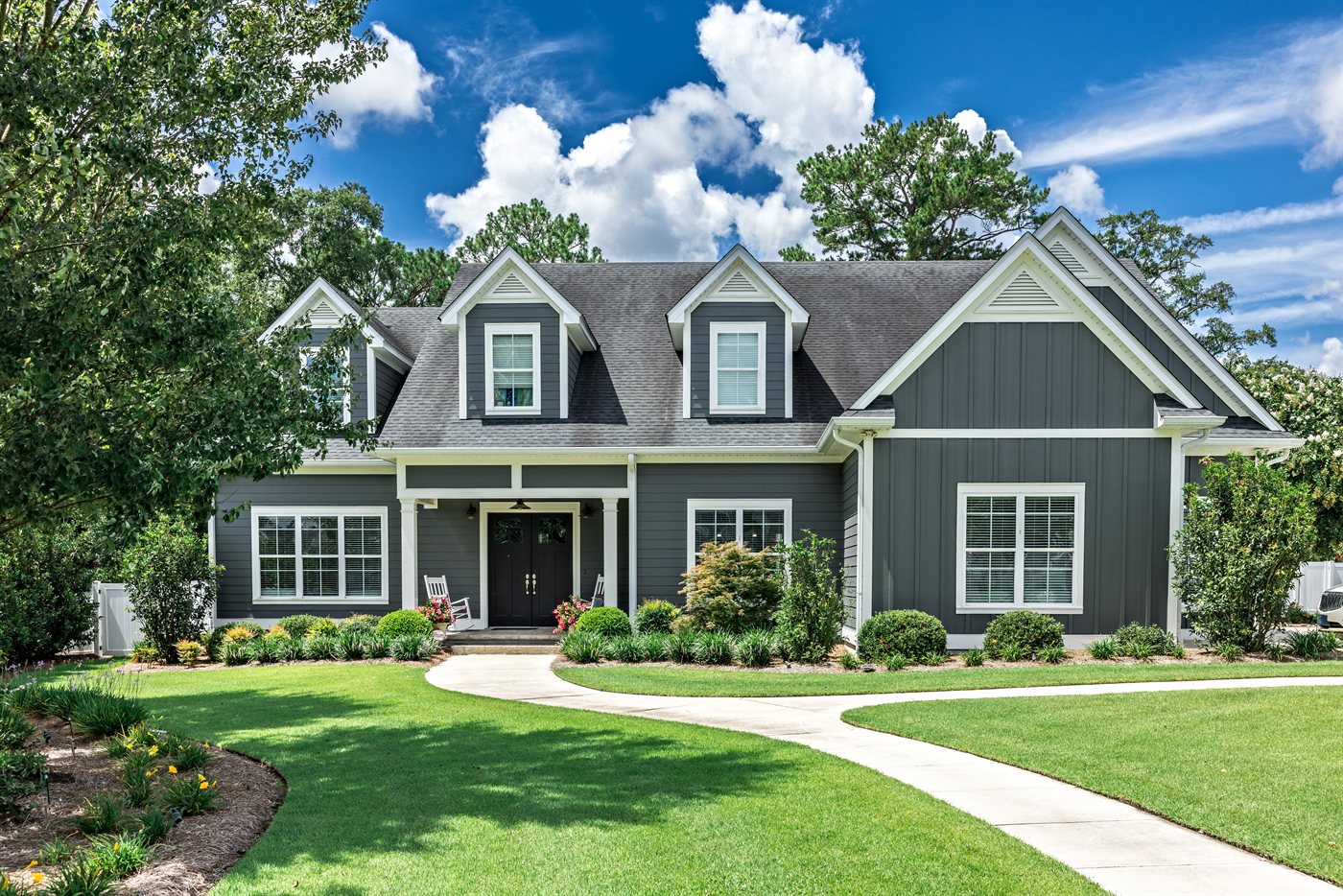 Brown lap siding bungalow with white trim and gable detail