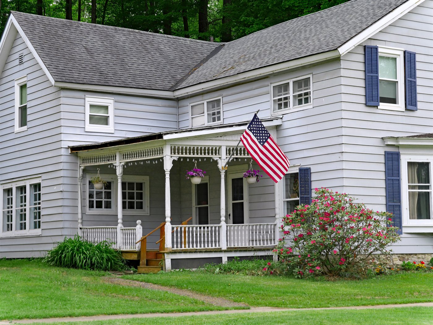 Seafoam green Hardie lap and board-and-batten siding with white trim